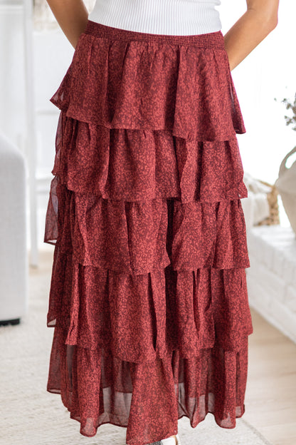 Red tiered skirt worn by a person in a minimal indoor setting
